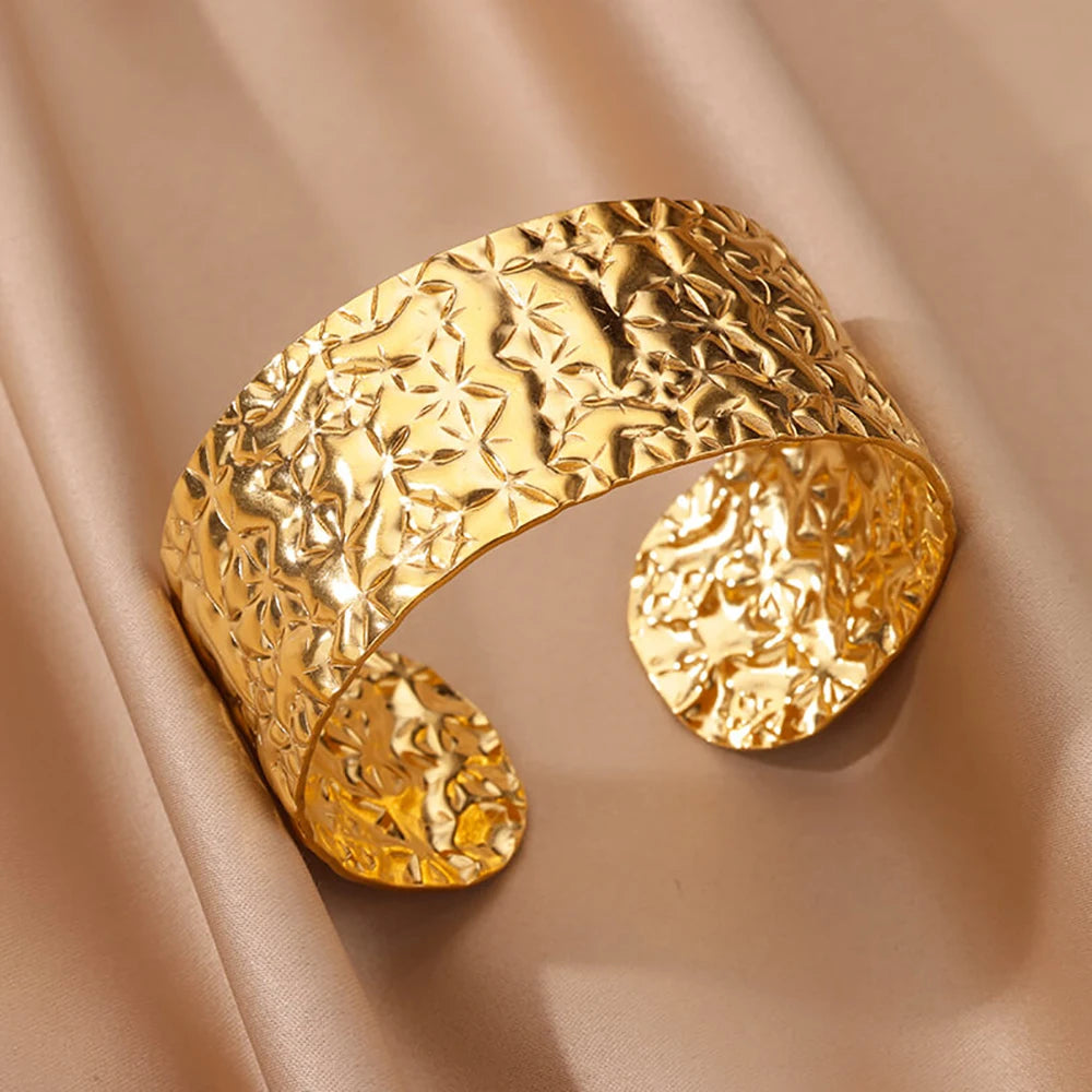 Cuff bangle with floral detail. Chunky or openwork, gold and silver