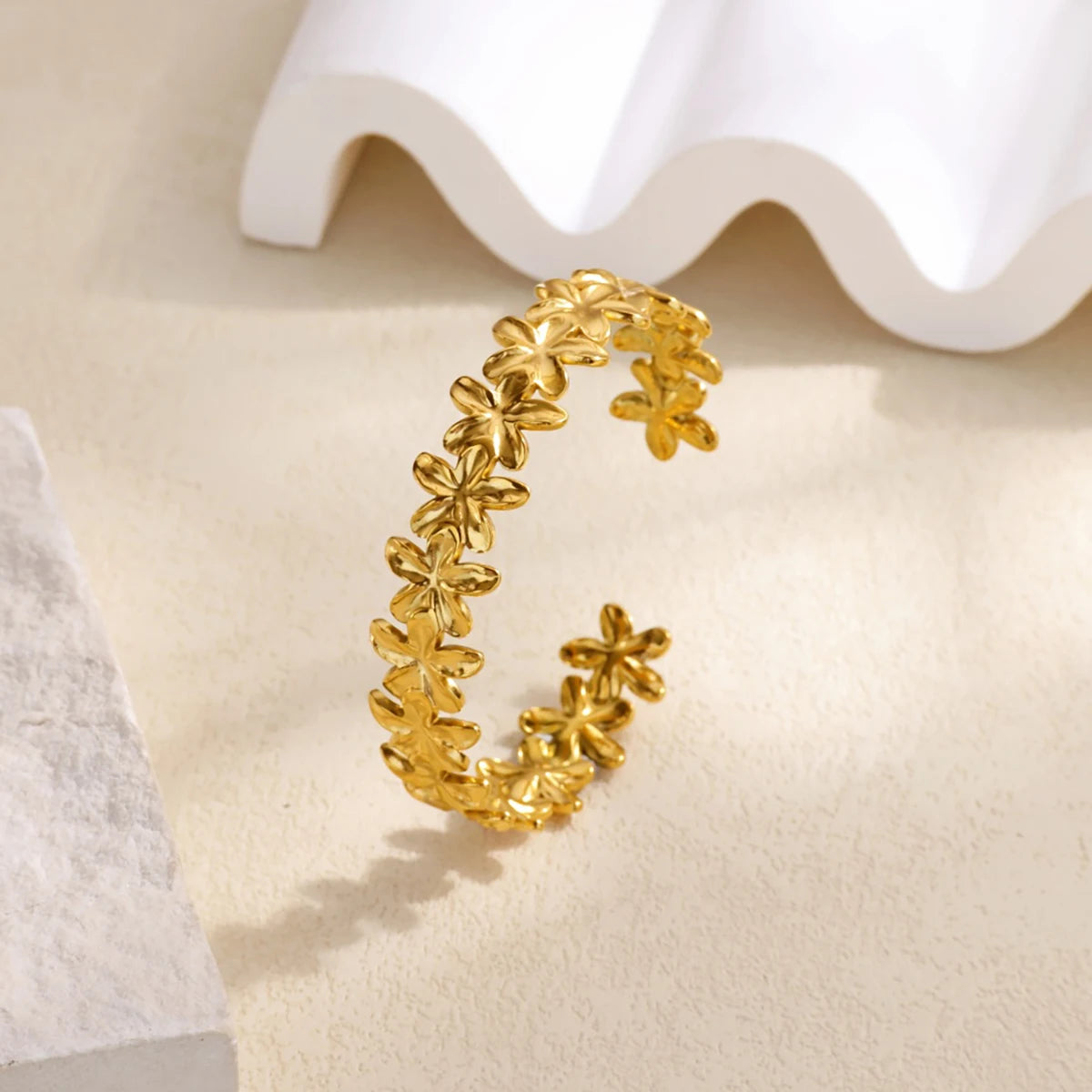 Cuff bangle with floral detail. Chunky or openwork, gold and silver