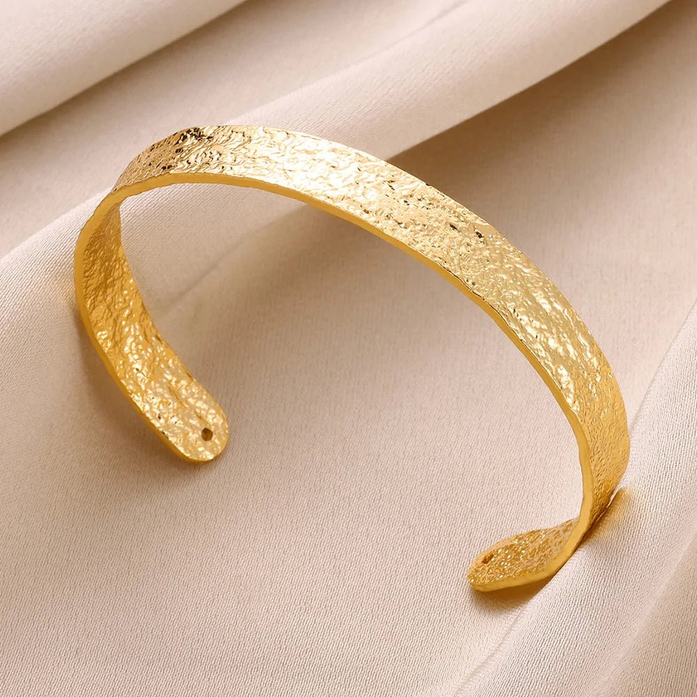 Cuff bangle with floral detail. Chunky or openwork, gold and silver