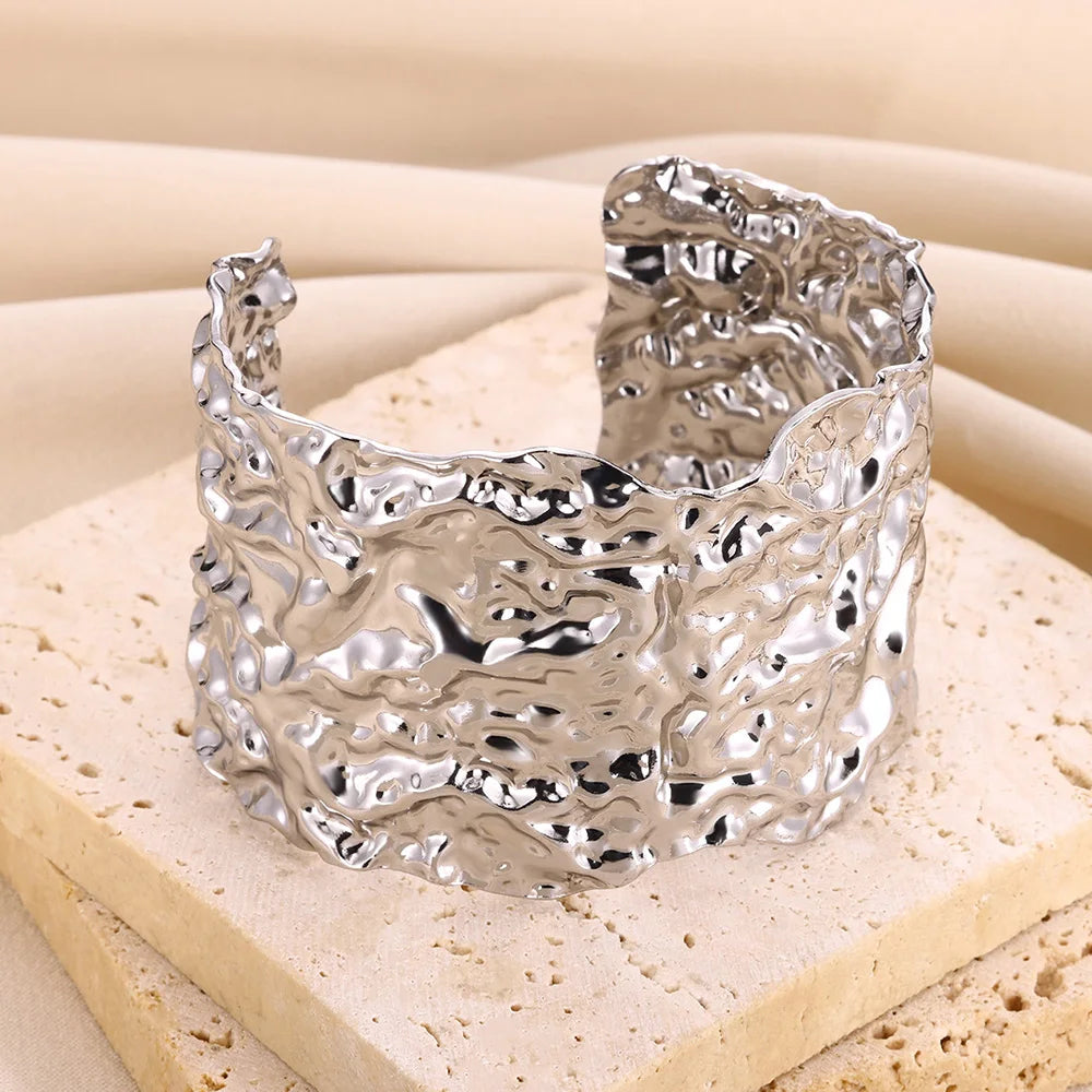 Cuff bangle with floral detail. Chunky or openwork, gold and silver