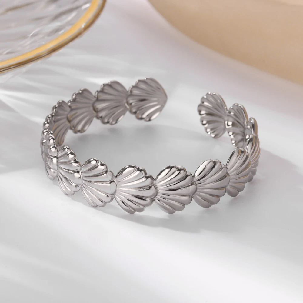 Cuff bangle with floral detail. Chunky or openwork, gold and silver