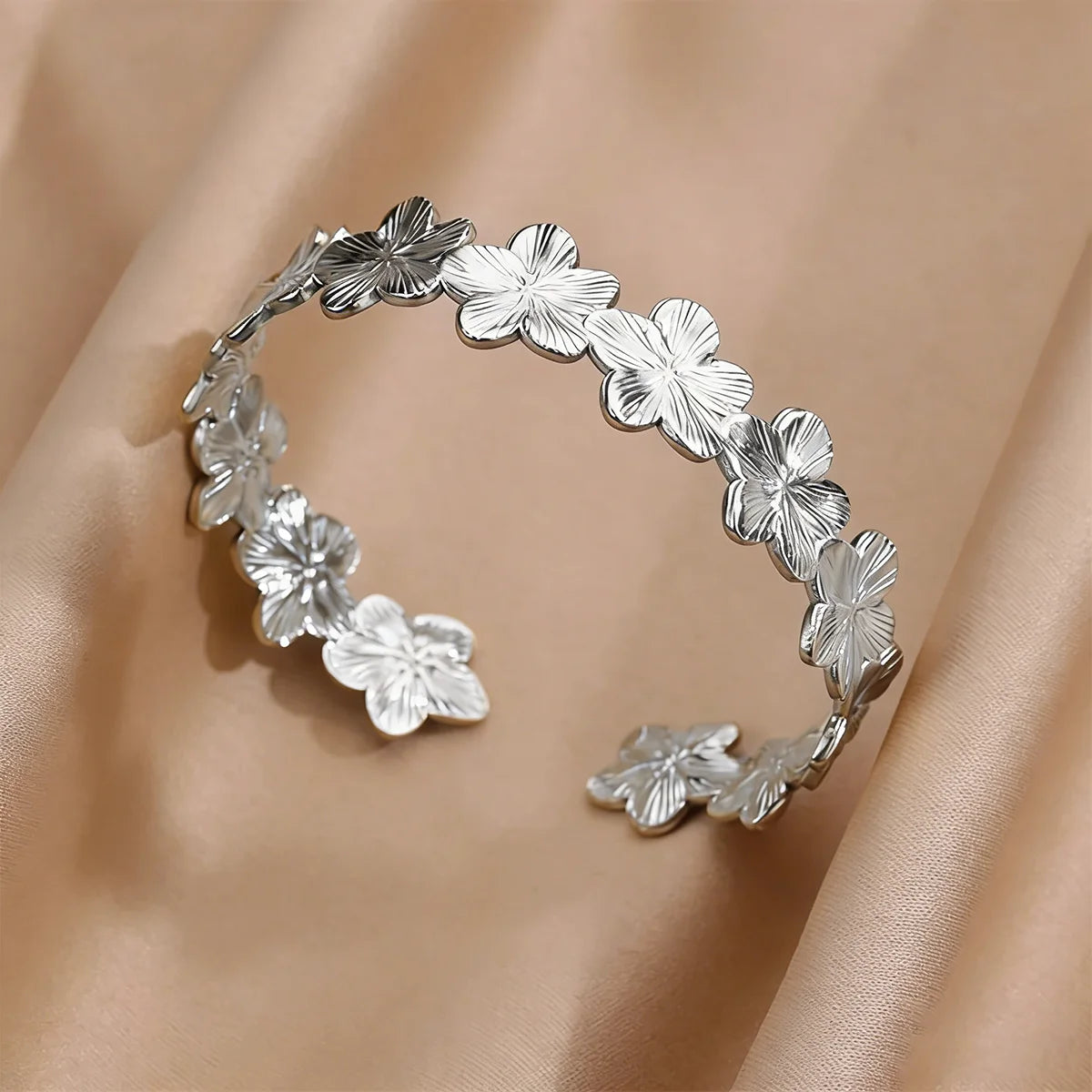 Cuff bangle with floral detail. Chunky or openwork, gold and silver