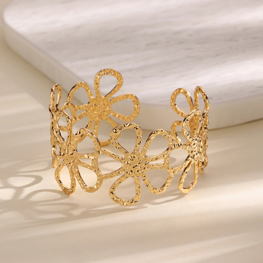 Cuff bangle with floral detail. Chunky or openwork, gold and silver