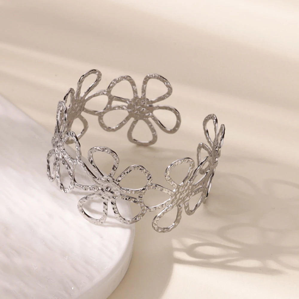 Cuff bangle with floral detail. Chunky or openwork, gold and silver