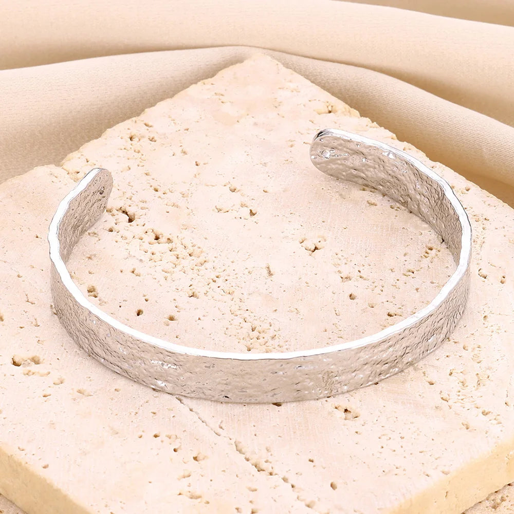 Cuff bangle with floral detail. Chunky or openwork, gold and silver