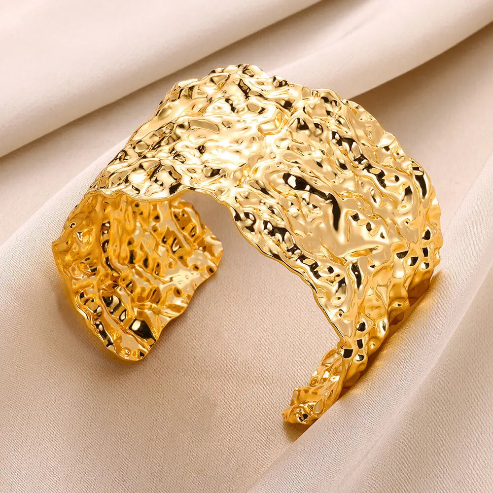Cuff bangle with floral detail. Chunky or openwork, gold and silver