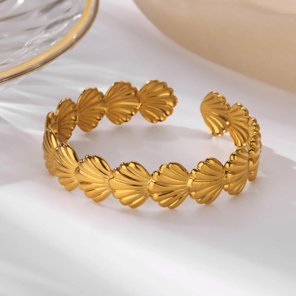 Cuff bangle with floral detail. Chunky or openwork, gold and silver