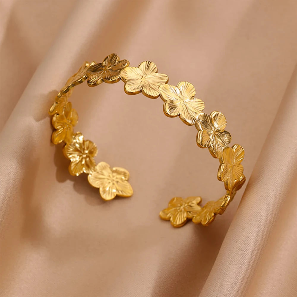 Cuff bangle with floral detail. Chunky or openwork, gold and silver
