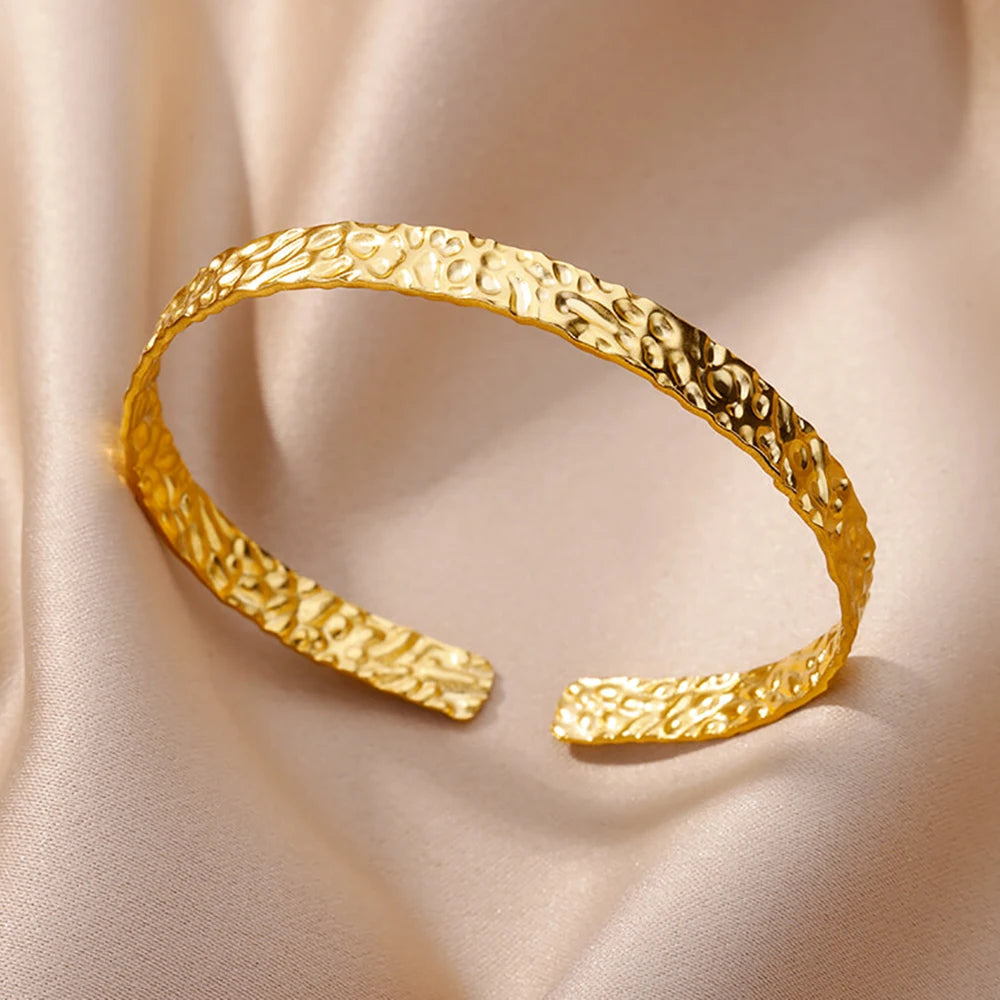 Cuff bangle with floral detail. Chunky or openwork, gold and silver