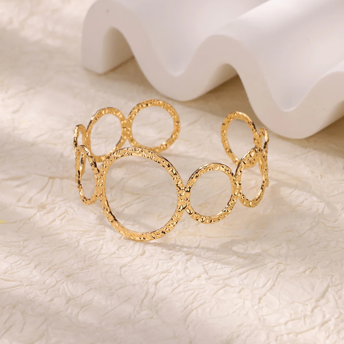 Cuff bangle with floral detail. Chunky or openwork, gold and silver