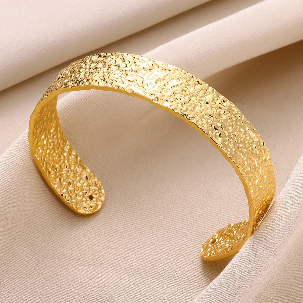 Cuff bangle with floral detail. Chunky or openwork, gold and silver