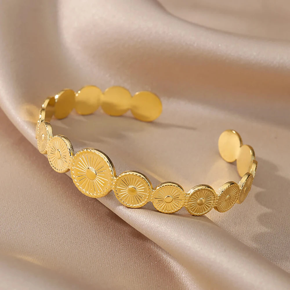 Cuff bangle with floral detail. Chunky or openwork, gold and silver